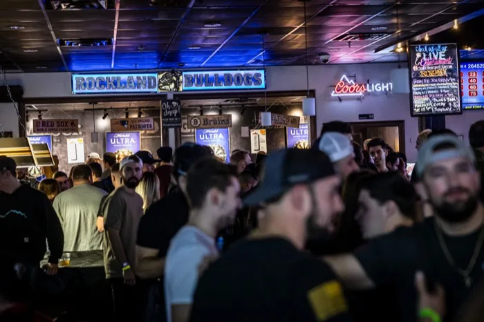 Crowd gathered under the Rockland Bulldogs sign watching the game