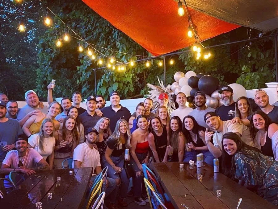 A large group celebrating together on the Players patio